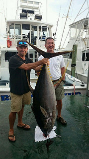 2 men holding their catch, big game fish