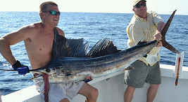 2 men holding big game fish they just caught