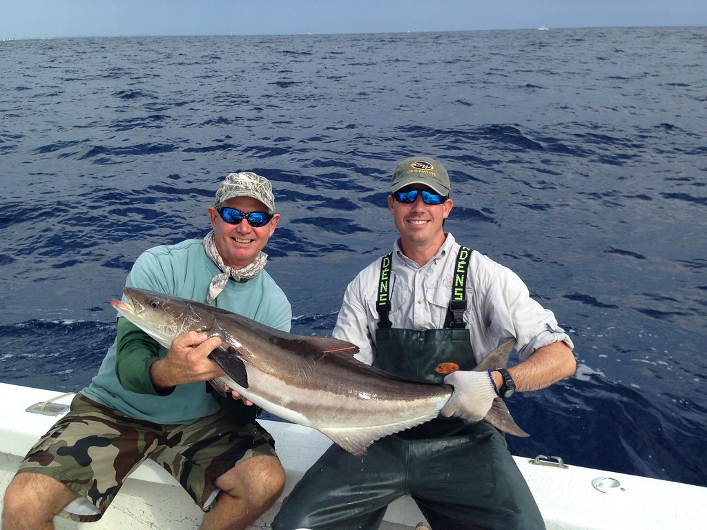 Two Fishermen Holding Cobia Fish