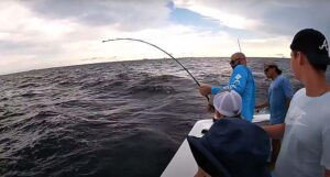 Fishermen reeling in deep sea fish on Finest Kind Charter Boat