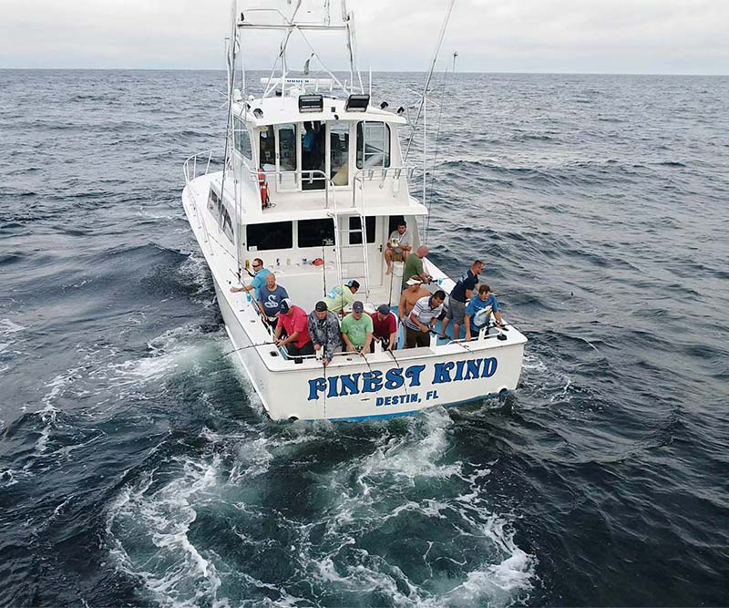 image of the back of finest kind fishing boat with fishmen