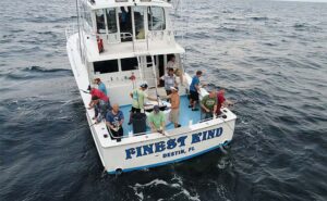 A closeup view of the Finest Kind Charter boat with guests fishing.