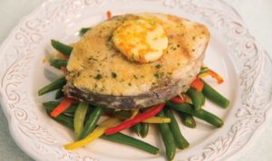 Florida king mackerel steak with herb citrus butter and snap peas