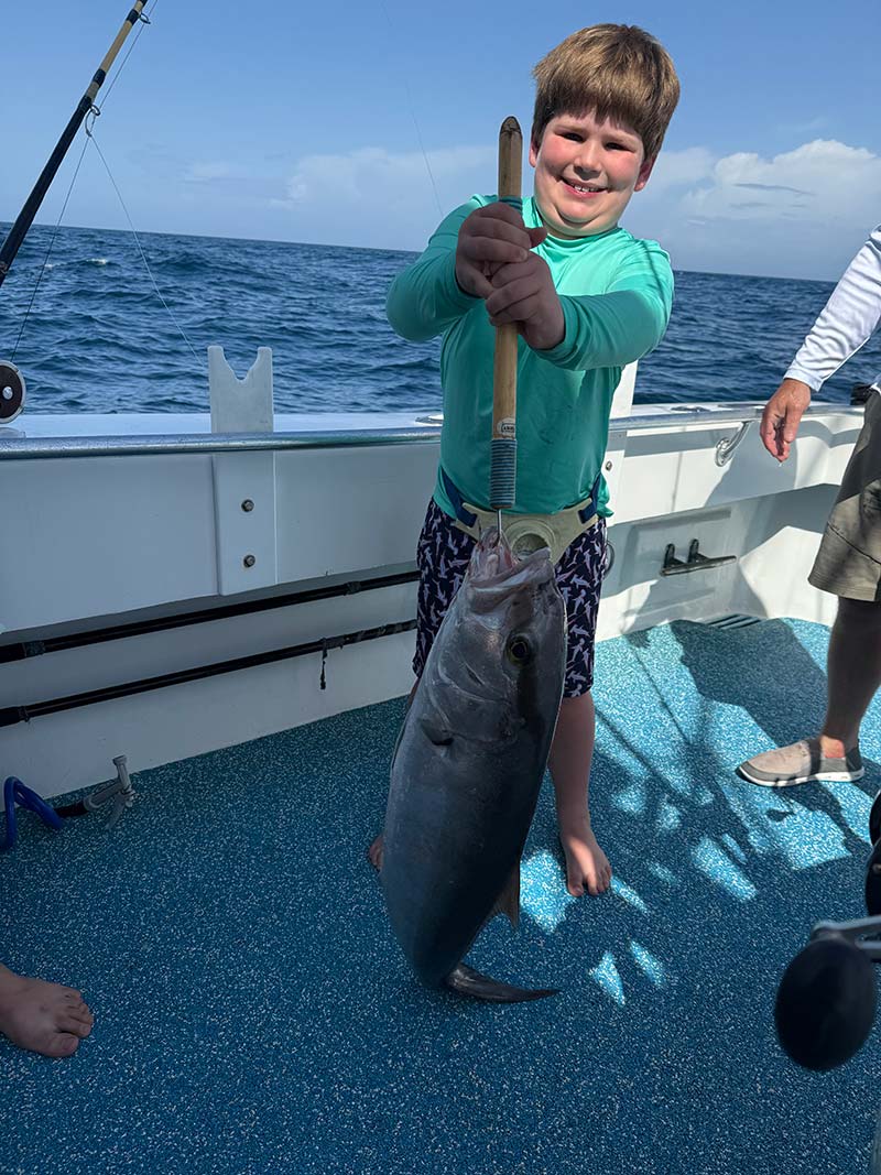 Kid with his Catch on The Finest Kind Charter Boat