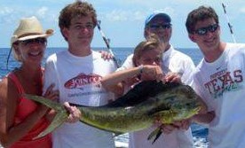 fisherman holding mahi catch